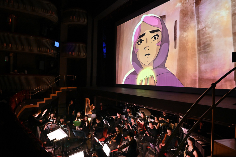 Film screen with live orchestra below